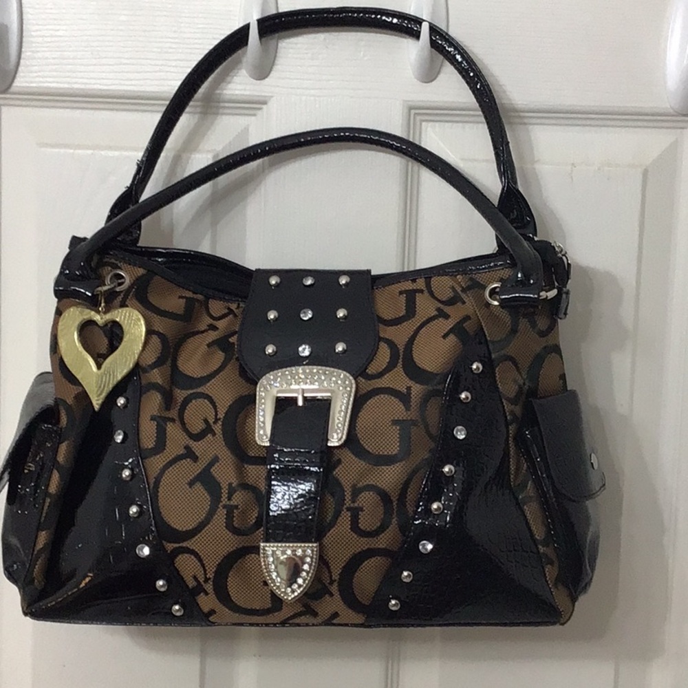 Large brown w/ black lettering design fabric handbag. Large main compartment.